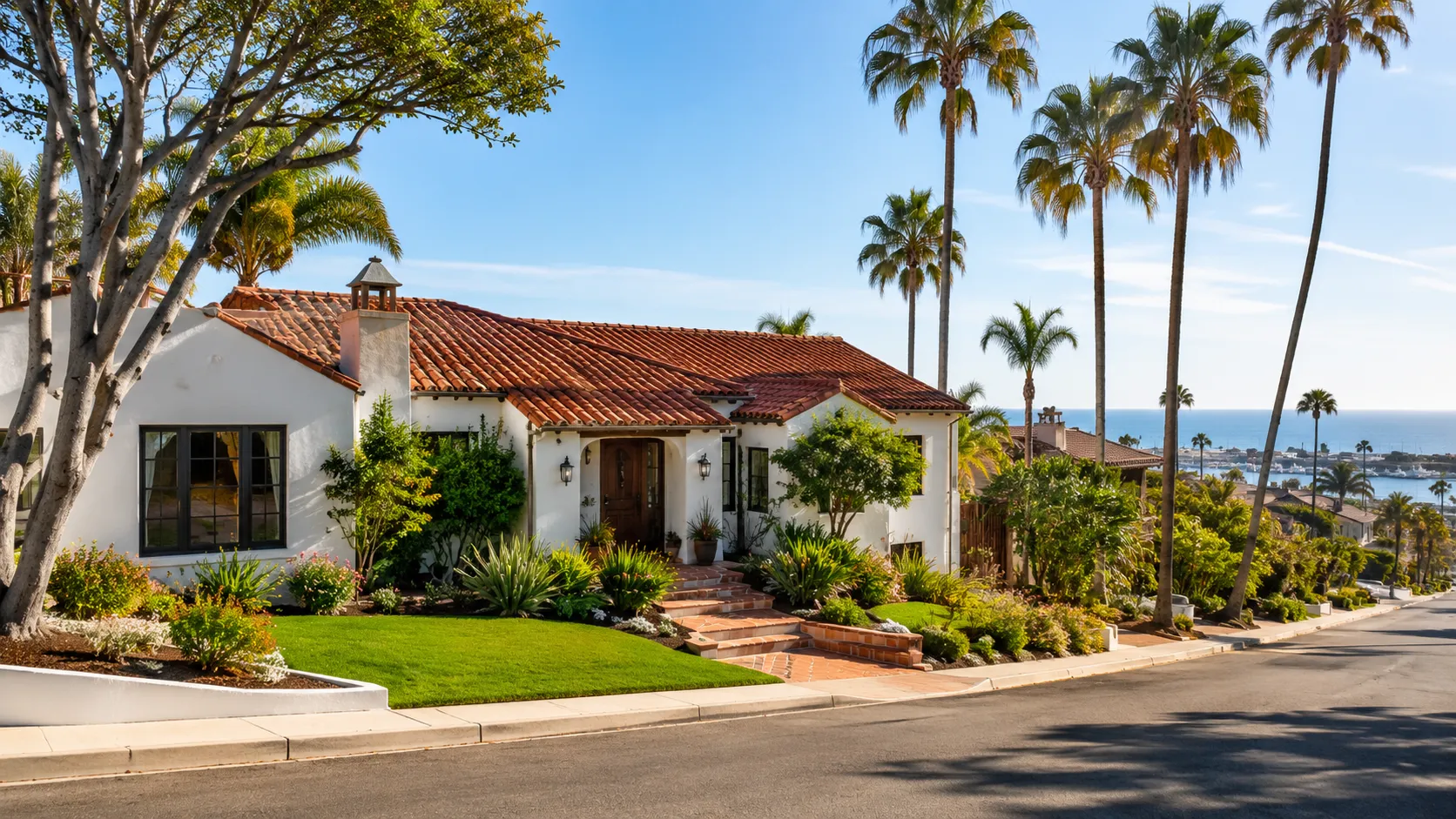 Mediterranean-style coastal home with palms